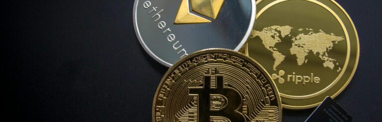 A striking image of Bitcoin, Ethereum, and Ripple coins illustrating modern digital currency.